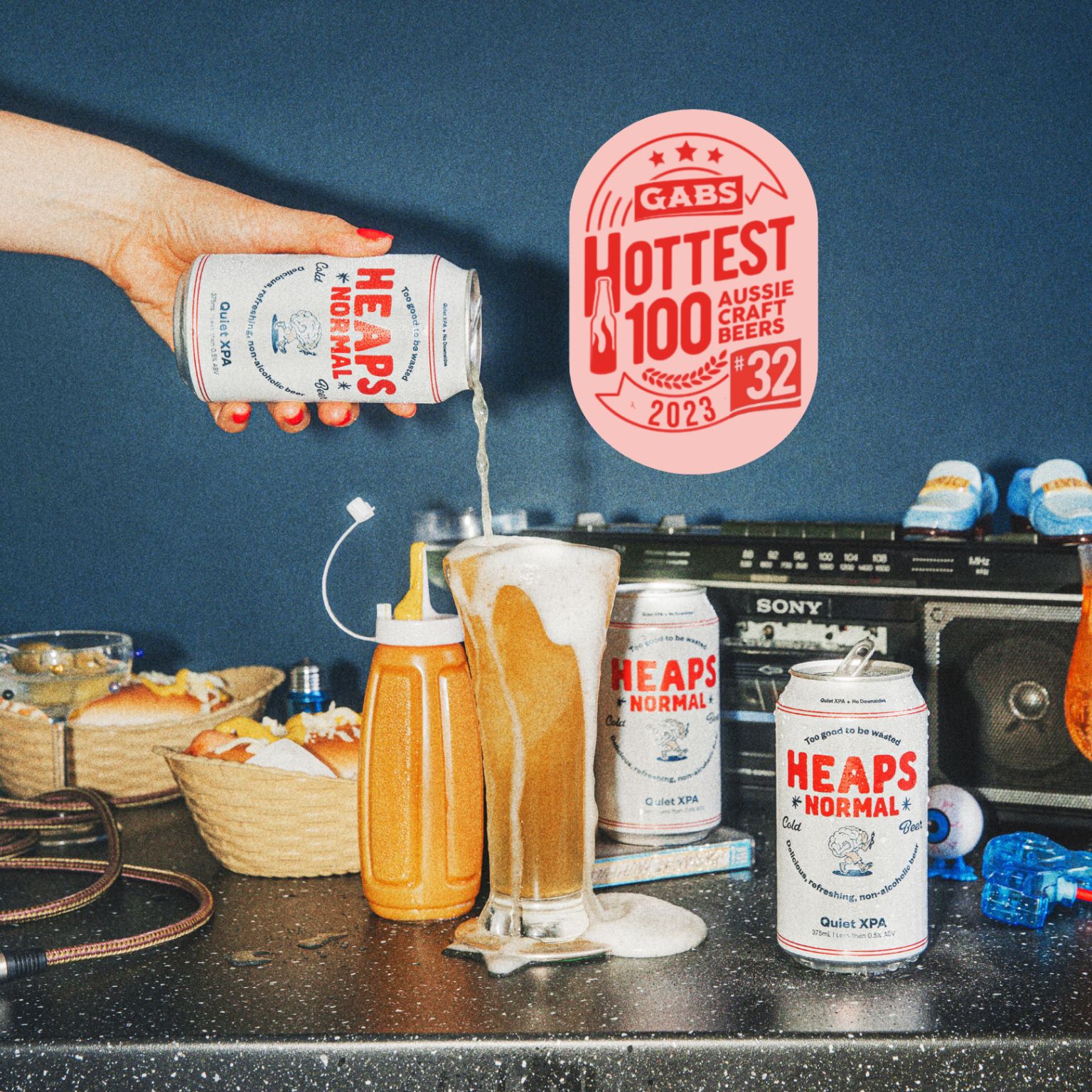 Heap Normal beer being poured and overflowing. Text saying Hottest 100 Beers.